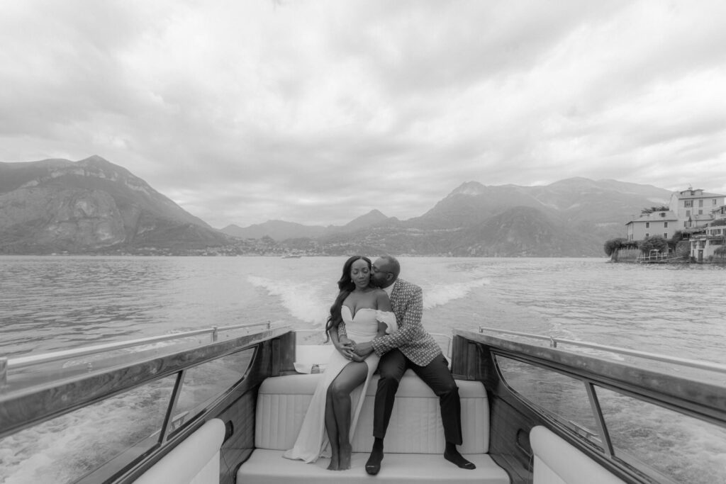 Bride and groom kissing on the boat during an elopement on Lago di Como