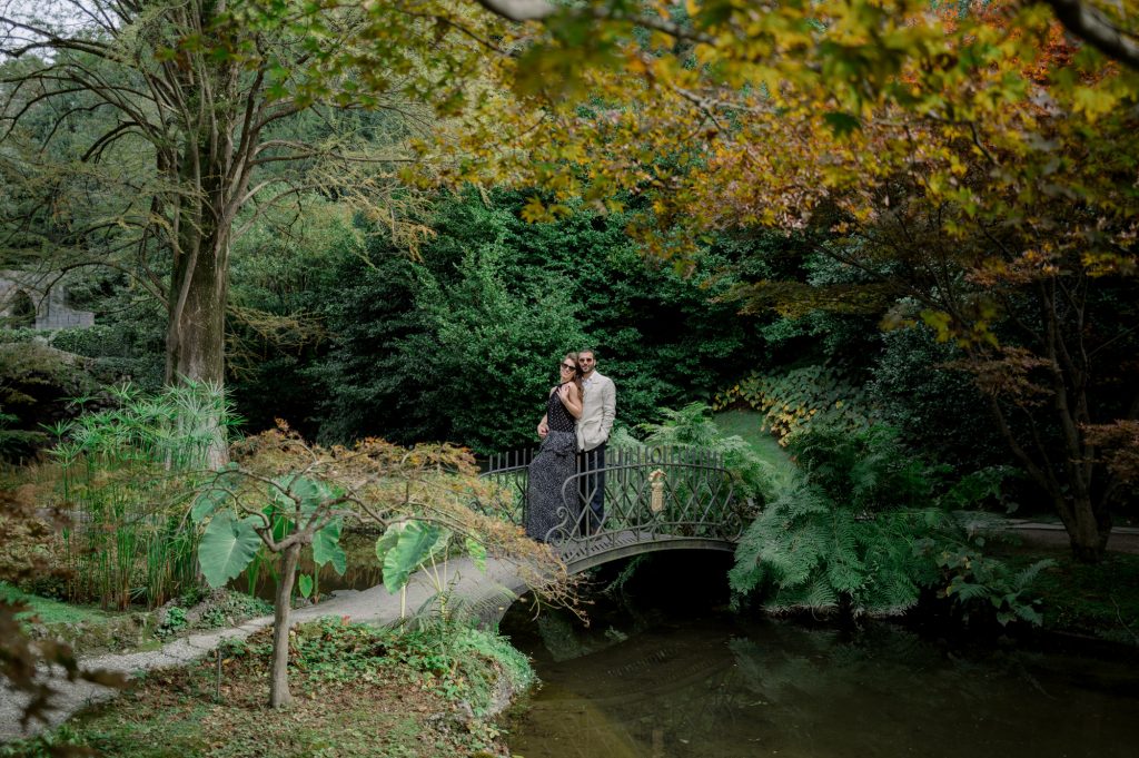 couple on the bridge of villa melzi in bellagio on lake como during an engagement