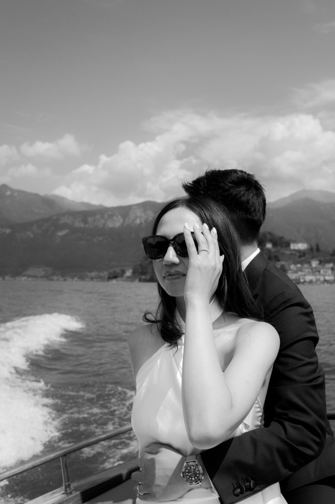 bride with sunglasses on the boat on lake como during their honeymoon, flash technique
