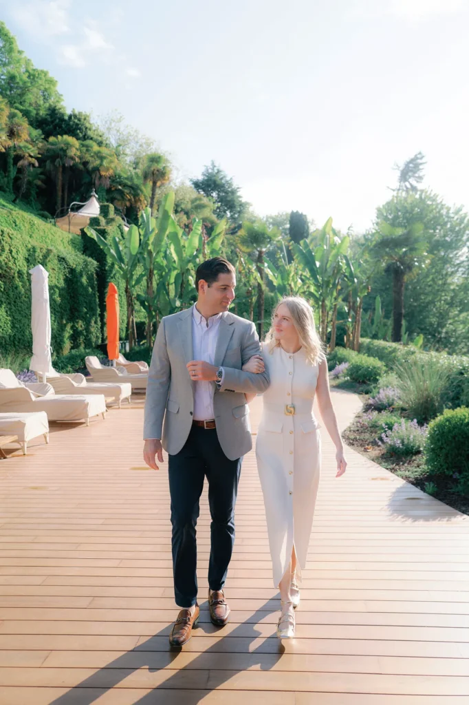Lifestyle photography of an engaged couple walking on the terrace in the gardens of Grand Hotel Tremezzo