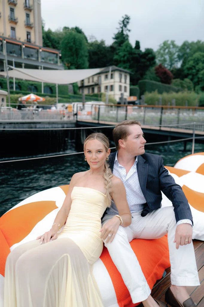 Couple celebrating their engagement by the iconic floating pool at Grand Hotel Tremezzo.