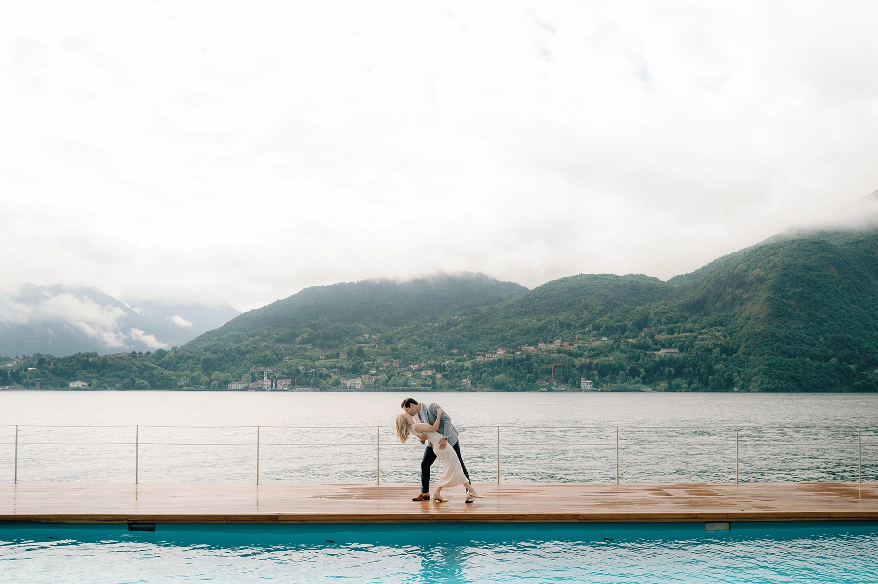 Couple celebrating their engagement by the iconic floating pool at Grand Hotel Tremezzo.