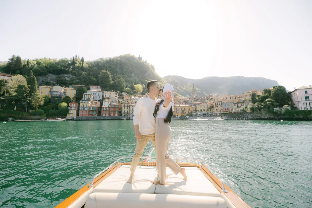 couple proposal photoshooting on a wooden boat in front of Varenna town on Lake Como
